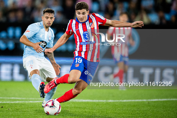 Julian Alvarez (R) of Atletico de Madrid fights for the ball with Fran Beltran (L) of RC Celta de Vigo during the LaLIGA EA SPORTS match bet...