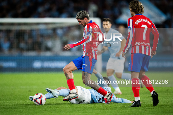 Rodrigo De Paul of Atletico de Madrid fights for the ball with Tasos Douvikas of RC Celta de Vigo during the LaLIGA EA SPORTS match between...