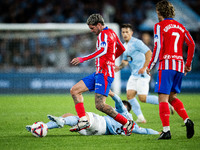 Rodrigo De Paul of Atletico de Madrid fights for the ball with Tasos Douvikas of RC Celta de Vigo during the LaLIGA EA SPORTS match between...