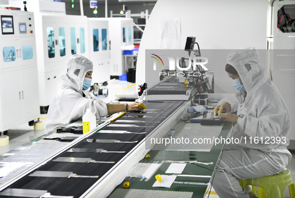 Workers at a liquid crystal display manufacturer work at Shanting Economic Development Zone in Zaozhuang, China, on September 25, 2024. 