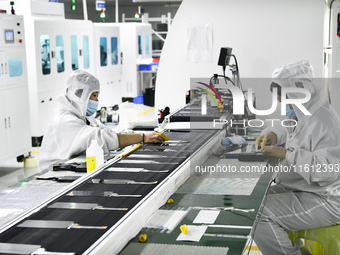 Workers at a liquid crystal display manufacturer work at Shanting Economic Development Zone in Zaozhuang, China, on September 25, 2024. (