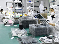 Workers at a liquid crystal display manufacturer work at Shanting Economic Development Zone in Zaozhuang, China, on September 25, 2024. (