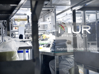 Workers at a liquid crystal display manufacturer work at Shanting Economic Development Zone in Zaozhuang, China, on September 25, 2024. (