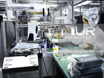 Workers at a liquid crystal display manufacturer work at Shanting Economic Development Zone in Zaozhuang, China, on September 25, 2024. (