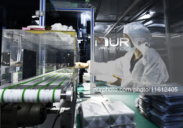 Workers at a liquid crystal display manufacturer work at Shanting Economic Development Zone in Zaozhuang, China, on September 25, 2024. 