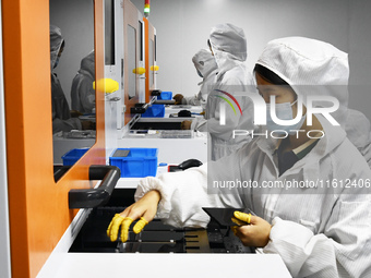 Workers at a liquid crystal display manufacturer work at Shanting Economic Development Zone in Zaozhuang, China, on September 25, 2024. (