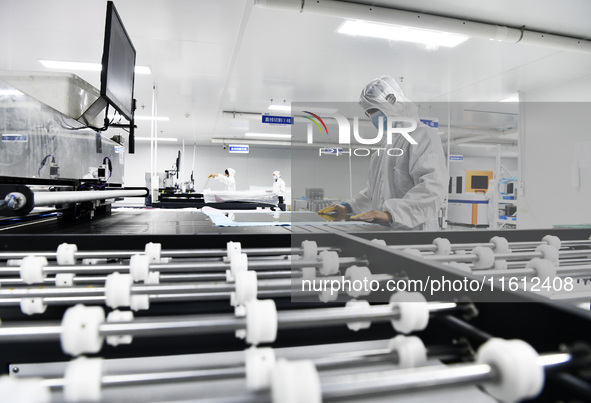 Workers at a liquid crystal display manufacturer work at Shanting Economic Development Zone in Zaozhuang, China, on September 25, 2024. 