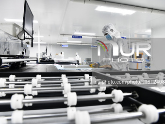 Workers at a liquid crystal display manufacturer work at Shanting Economic Development Zone in Zaozhuang, China, on September 25, 2024. (