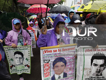 Mothers and fathers of the 43 missing Ayotzinapa students march from the Angel of Independence to the Zocalo in Mexico City, Mexico, on Sept...