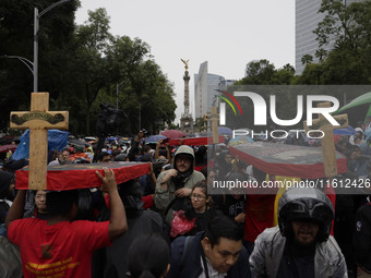 Mothers and fathers of the 43 missing Ayotzinapa students march from the Angel of Independence to the Zocalo in Mexico City, Mexico, on Sept...