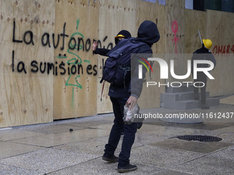 Members of the anarchist Black Bloc carry out direct action while accompanying the mothers and fathers of the 43 disappeared Ayotzinapa stud...