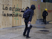 Members of the anarchist Black Bloc carry out direct action while accompanying the mothers and fathers of the 43 disappeared Ayotzinapa stud...