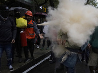 Members of the anarchist Black Bloc carry out direct action while accompanying the mothers and fathers of the 43 disappeared Ayotzinapa stud...