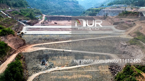 Workers work at the construction site of the Jiangjiakou Reservoir project in Jiangjiakou town, Bazhong, China, on September 25, 2024. 