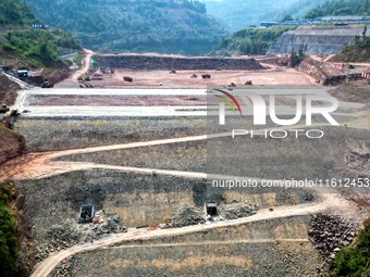 Workers work at the construction site of the Jiangjiakou Reservoir project in Jiangjiakou town, Bazhong, China, on September 25, 2024. (