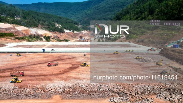 Workers work at the construction site of the Jiangjiakou Reservoir project in Jiangjiakou town, Bazhong, China, on September 25, 2024. 