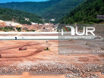 Workers work at the construction site of the Jiangjiakou Reservoir project in Jiangjiakou town, Bazhong, China, on September 25, 2024. (