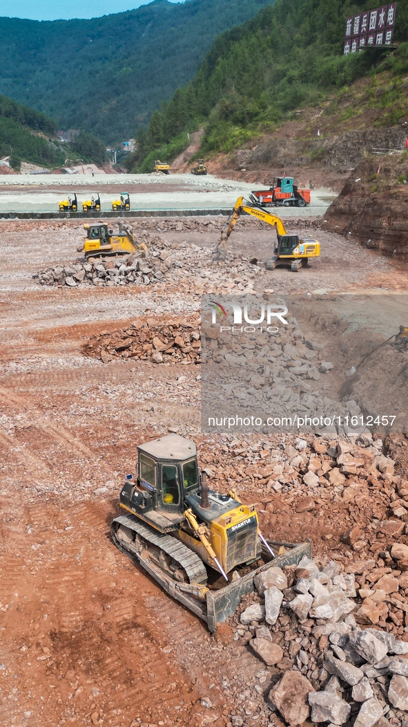 Workers work at the construction site of the Jiangjiakou Reservoir project in Jiangjiakou town, Bazhong, China, on September 25, 2024. 