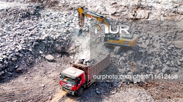 Workers work at the construction site of the Jiangjiakou Reservoir project in Jiangjiakou town, Bazhong, China, on September 25, 2024. 