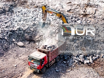 Workers work at the construction site of the Jiangjiakou Reservoir project in Jiangjiakou town, Bazhong, China, on September 25, 2024. (