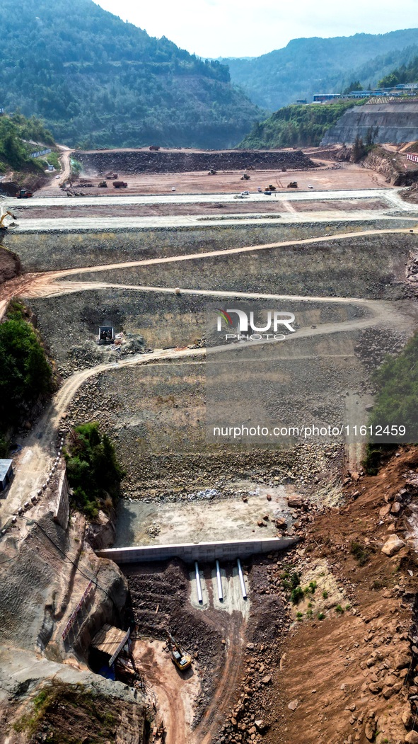 Workers work at the construction site of the Jiangjiakou Reservoir project in Jiangjiakou town, Bazhong, China, on September 25, 2024. 