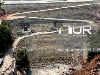 Workers work at the construction site of the Jiangjiakou Reservoir project in Jiangjiakou town, Bazhong, China, on September 25, 2024. (