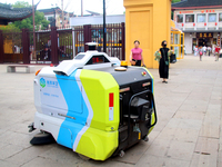 An intelligent sweeping robot works at Xuanmiaiguan Square on Guanqian Street in Suzhou, China, on September 27, 2024. (