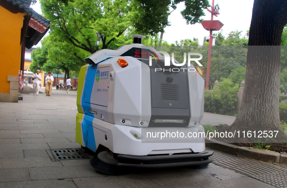 An intelligent sweeping robot works at Xuanmiaiguan Square on Guanqian Street in Suzhou, China, on September 27, 2024. 