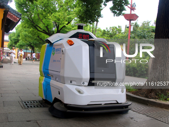 An intelligent sweeping robot works at Xuanmiaiguan Square on Guanqian Street in Suzhou, China, on September 27, 2024. (