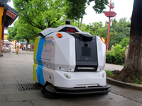 An intelligent sweeping robot works at Xuanmiaiguan Square on Guanqian Street in Suzhou, China, on September 27, 2024. (