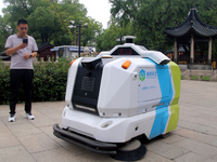 An intelligent sweeping robot works at Xuanmiaiguan Square on Guanqian Street in Suzhou, China, on September 27, 2024. (