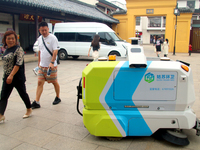 An intelligent sweeping robot works at Xuanmiaiguan Square on Guanqian Street in Suzhou, China, on September 27, 2024. (