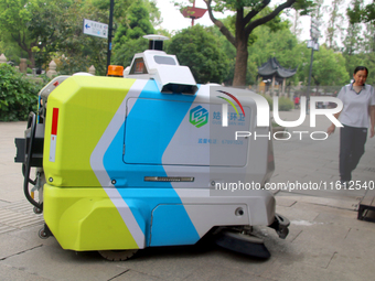 An intelligent sweeping robot works at Xuanmiaiguan Square on Guanqian Street in Suzhou, China, on September 27, 2024. (