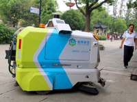 An intelligent sweeping robot works at Xuanmiaiguan Square on Guanqian Street in Suzhou, China, on September 27, 2024. (