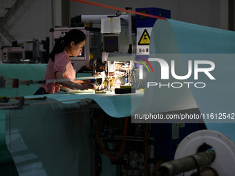 A worker produces paper-making nets at Pacific Special Nets Co., LTD in Fuyang, China, on September 27, 2024. (