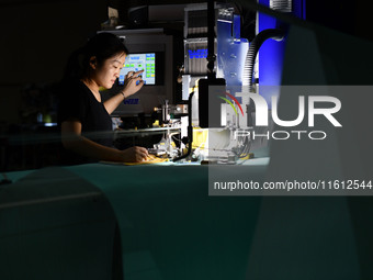 A worker produces paper-making nets at Pacific Special Nets Co., LTD in Fuyang, China, on September 27, 2024. (