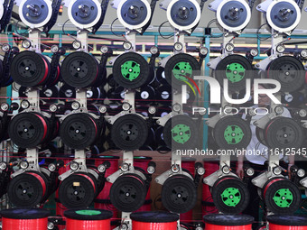 A worker works on a paper-making net production line at Pacific Special Mesh Co., LTD in Fuyang, China, on September 27, 2024. (