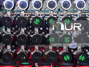 A worker works on a paper-making net production line at Pacific Special Mesh Co., LTD in Fuyang, China, on September 27, 2024. (