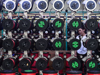 A worker works on a paper-making net production line at Pacific Special Mesh Co., LTD in Fuyang, China, on September 27, 2024. (