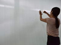 A worker checks the quality of paper-making nets at Pacific Special Nets Co., LTD in Fuyang, China, on September 27, 2024. (