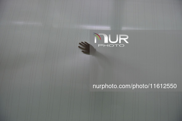 A worker checks the quality of paper-making nets at Pacific Special Nets Co., LTD in Fuyang, China, on September 27, 2024. 