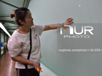 A worker checks the quality of paper-making nets at Pacific Special Nets Co., LTD in Fuyang, China, on September 27, 2024. (