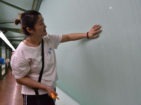 A worker checks the quality of paper-making nets at Pacific Special Nets Co., LTD in Fuyang, China, on September 27, 2024. (