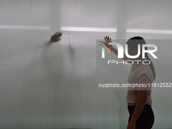 A worker checks the quality of paper-making nets at Pacific Special Nets Co., LTD in Fuyang, China, on September 27, 2024. (