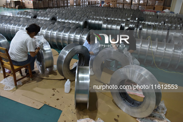 A worker cleans a tray at Pacific Special Mesh Industry Co., LTD in Fuyang, China, on September 27, 2024. 