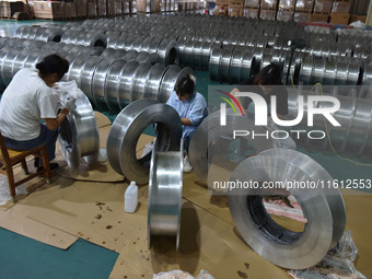 A worker cleans a tray at Pacific Special Mesh Industry Co., LTD in Fuyang, China, on September 27, 2024. (