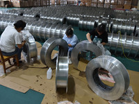 A worker cleans a tray at Pacific Special Mesh Industry Co., LTD in Fuyang, China, on September 27, 2024. (