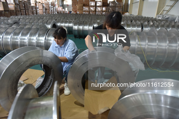 A worker cleans a tray at Pacific Special Mesh Industry Co., LTD in Fuyang, China, on September 27, 2024. 