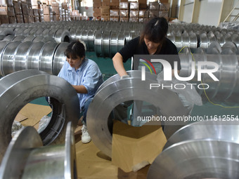 A worker cleans a tray at Pacific Special Mesh Industry Co., LTD in Fuyang, China, on September 27, 2024. (