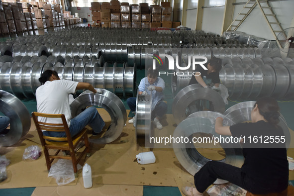 A worker cleans a tray at Pacific Special Mesh Industry Co., LTD in Fuyang, China, on September 27, 2024. 